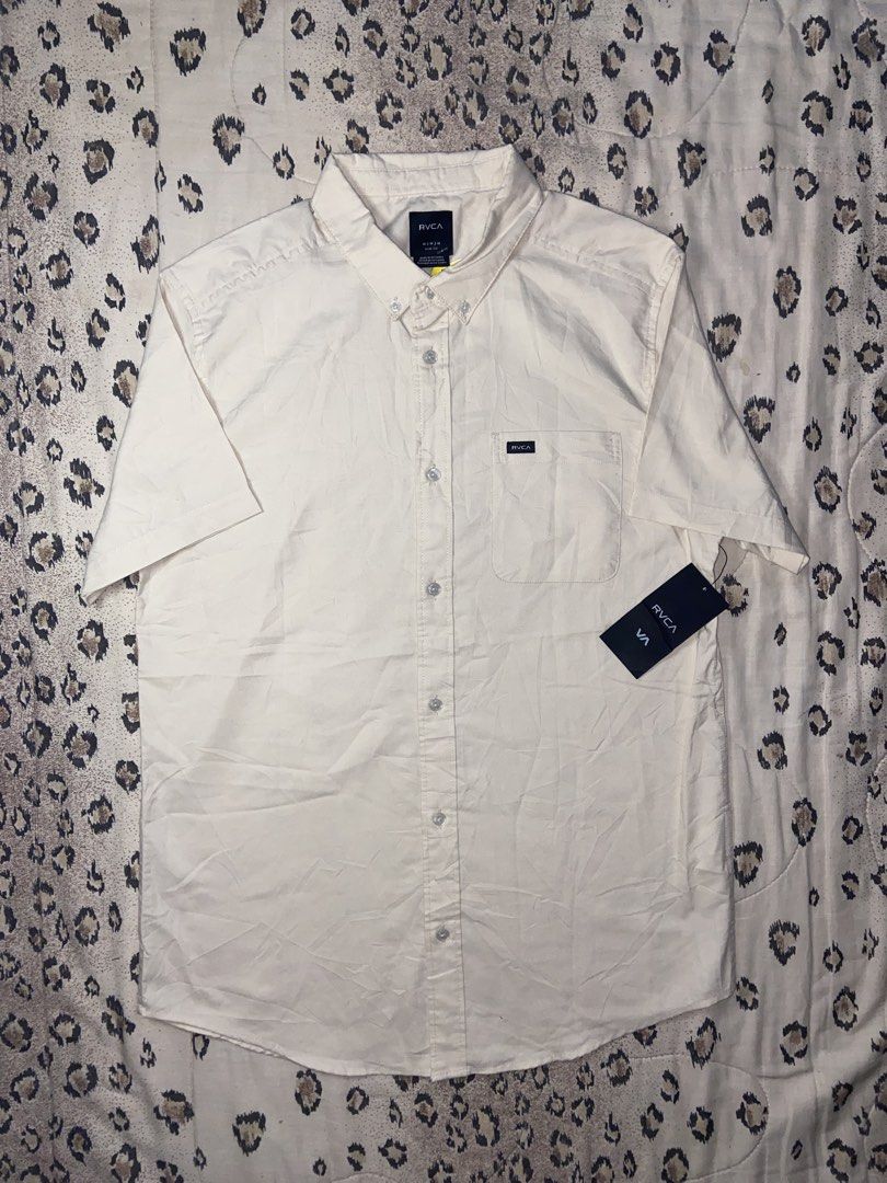 RVCA Short Sleeve Button Down Shirt Slim Fit Medium (Category: Tshirts & Polo Shirts ) located in Manila. Submitted by nix.thrift (Listing ID 1468608246, Image 1). Description: - Brand: RVCA - Style: Short sleeve button-down shirt with button-down collar - Color: Cream - Size: Men's Medium (Slim Fit) - Details: Single chest pocket with woven brand label - Condition: Brand new with original tags attached, unworn.