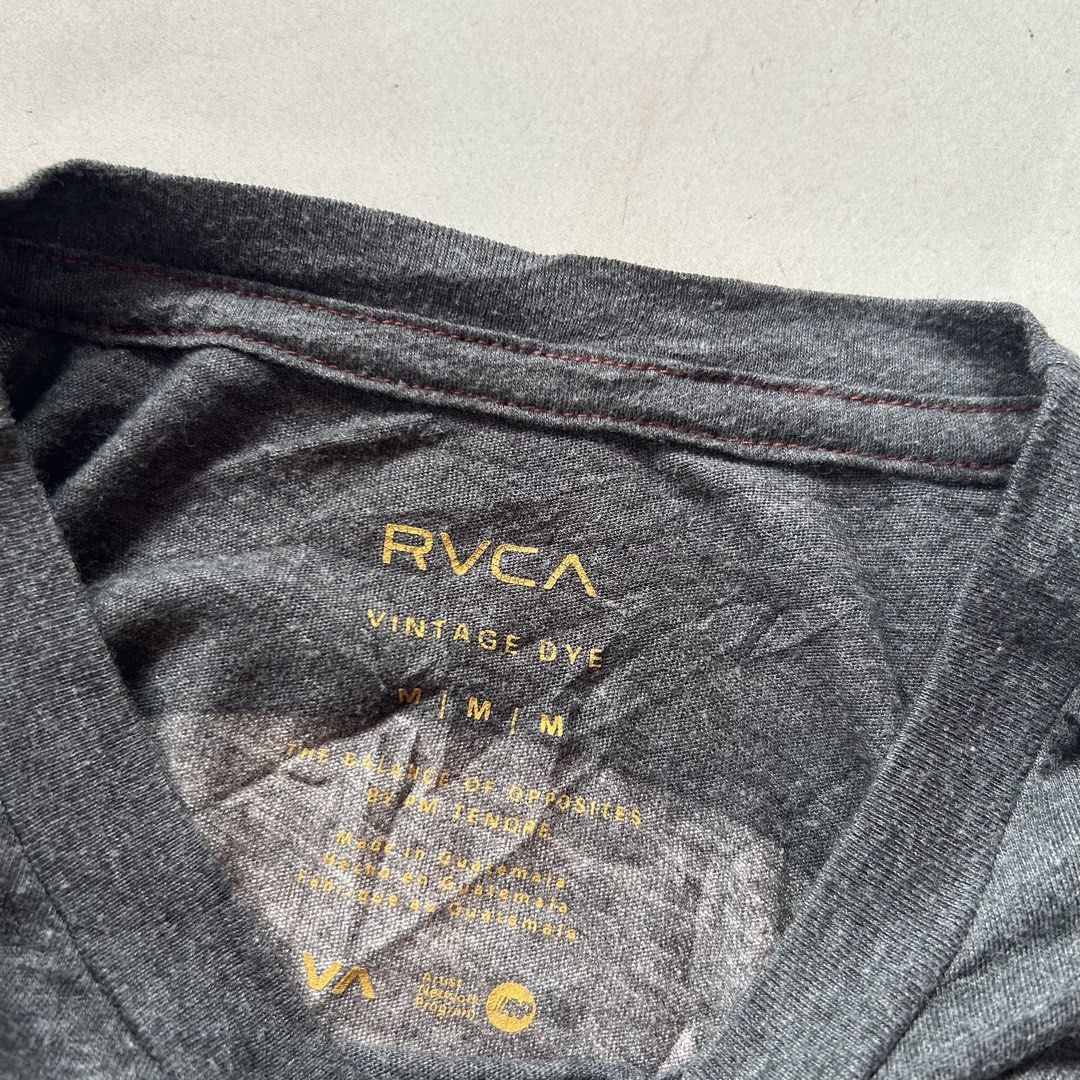 RVCA x Sage Vaughn 🔥 (Category: Tshirts & Polo Shirts ) located in Jinoba-an. Submitted by eegiboy (Listing ID 1468546892, Image 3). Description: - Brand: RVCA x Sage Vaughn collaboration - Color: Dark grey vintage wash - Size: Medium (Regular fit) - Material: Soft cotton blend - Details: Graphic print on chest pocket area, large back print, and white embroidered RVCA logo on the sleeve - Condition: Excellent Wts: Rvca shirt 🔥 Medium size Dimes