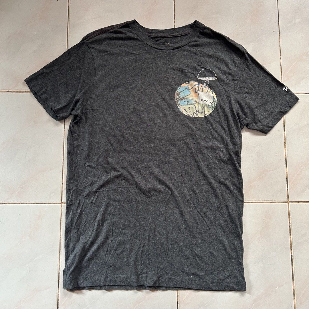 RVCA x Sage Vaughn 🔥 (Category: Tshirts & Polo Shirts ) located in Jinoba-an. Submitted by eegiboy (Listing ID 1468546892, Image 1). Description: - Brand: RVCA x Sage Vaughn collaboration - Color: Dark grey vintage wash - Size: Medium (Regular fit) - Material: Soft cotton blend - Details: Graphic print on chest pocket area, large back print, and white embroidered RVCA logo on the sleeve - Condition: Excellent Wts: Rvca shirt 🔥 Medium size Dimes