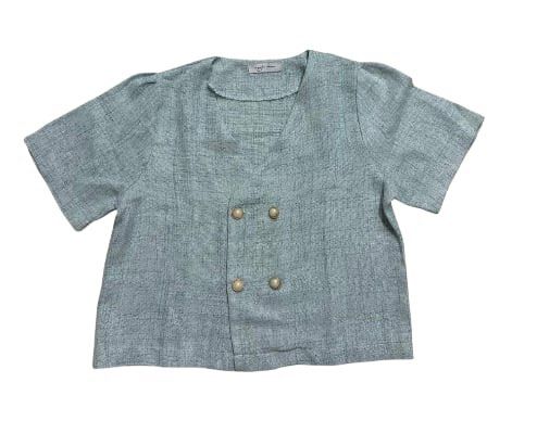 Sage Green Double Breasted Short Sleeve Blouse (Category: Blouses) located in Manila. Submitted by dechlotter_ (Listing ID 1468632416, Image 1). Description: - Color: Sage green - Style: Double-breasted short sleeve blouse with V-neckline - Details: Textured fabric finish with four metallic round buttons - Fit: Regular fit with clean stitching along the hem and sleeves - Perfect for: Warm weather casual wear.