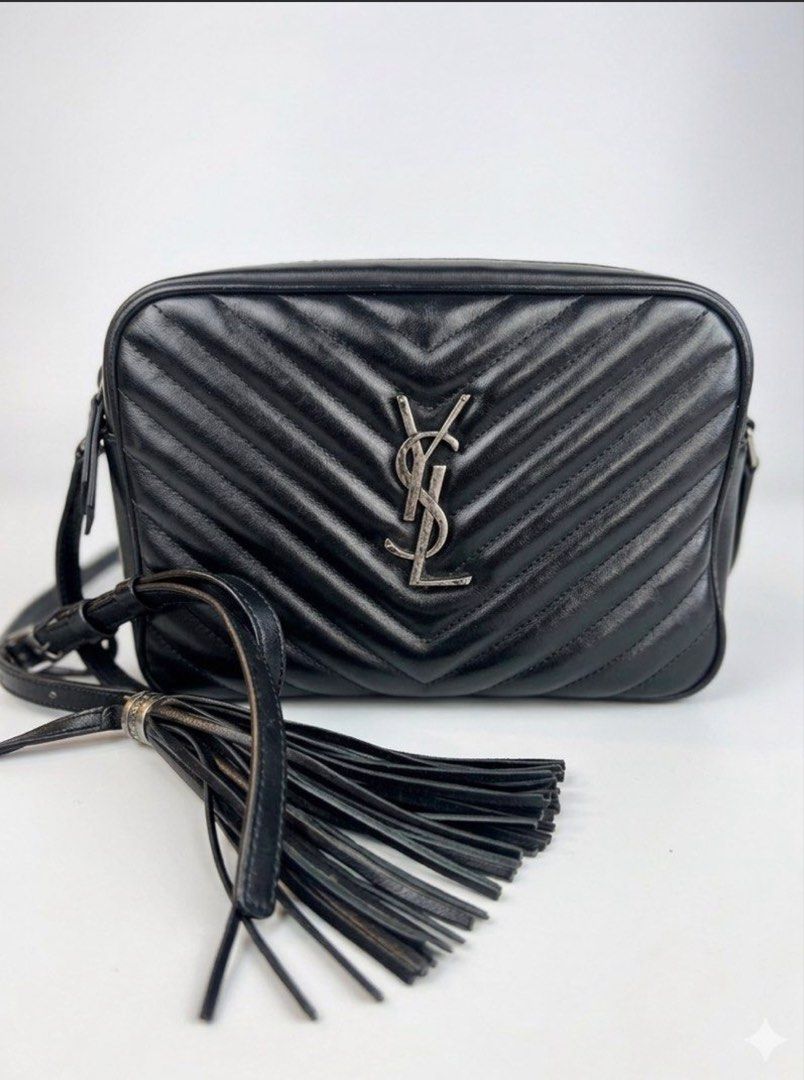 Saint Laurent Lou Camera Bag Black Silver Hardware (Category: Luxury Bags & Wallets) located in Mandaluyong City. Submitted by lucky_len77 (Listing ID 1468672180, Image 1). Description: - Brand: Saint Laurent (YSL) - Material: Black chevron quilted leather with subtle grain texture - Hardware: Silver-tone with iconic front YSL monogram - Details: Matching leather tassel zipper pull and adjustable shoulder strap - Interior: Fabric lining with leat