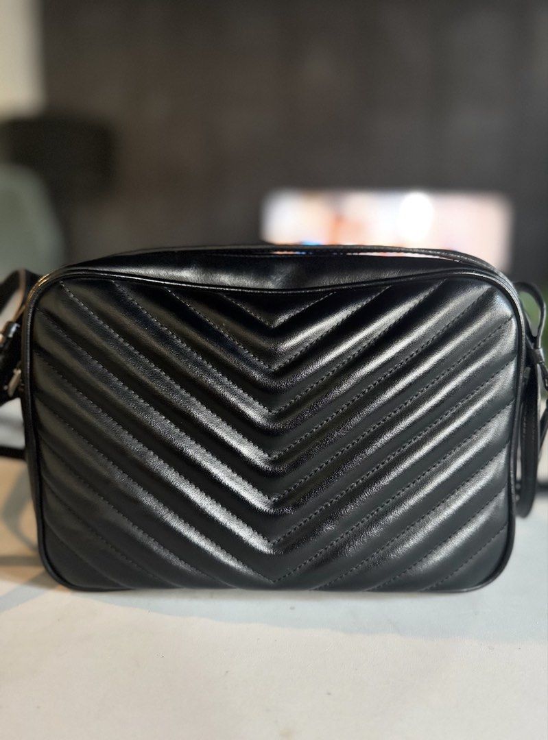 Saint Laurent Lou Camera Bag Black Silver Hardware (Category: Luxury Bags & Wallets) located in Mandaluyong City. Submitted by lucky_len77 (Listing ID 1468672180, Image 3). Description: - Brand: Saint Laurent (YSL) - Material: Black chevron quilted leather with subtle grain texture - Hardware: Silver-tone with iconic front YSL monogram - Details: Matching leather tassel zipper pull and adjustable shoulder strap - Interior: Fabric lining with leat