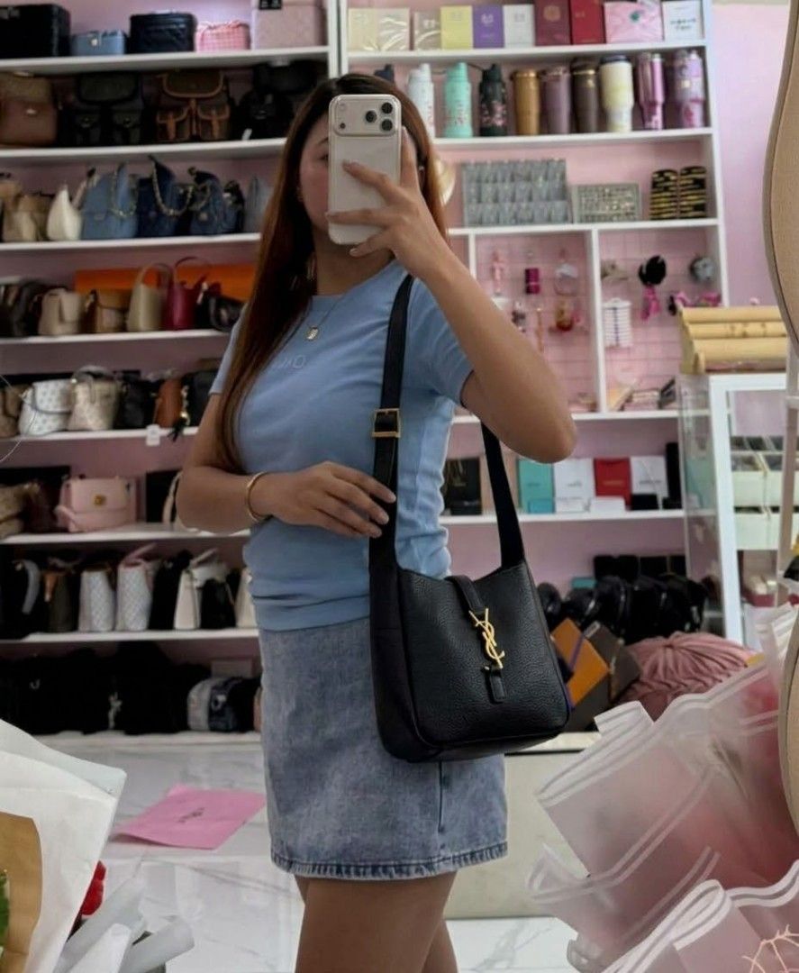 Saint Laurent (YSL) (Category: Luxury Bags & Wallets) located in Bacolod. Submitted by lux.antithrifts (Listing ID 1468628221, Image 2). Description: Brand: Saint Laurent (YSL) Model: Le 5 à 7 Supple Small Hobo Bag Color: Black Material: Grained Calfskin Leather with a soft, supple texture and tonal suede lining. Hardware: Light bronze / gold-tone metal hardware featuring the iconic Cassandre (YSL) logo leather tab closure..