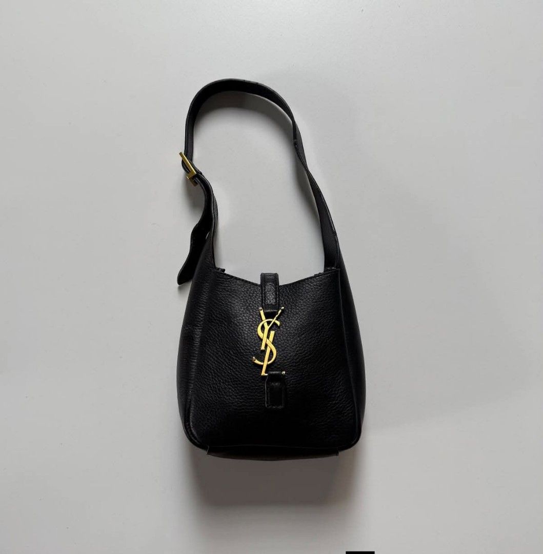 Saint Laurent (YSL) (Category: Luxury Bags & Wallets) located in Bacolod. Submitted by lux.antithrifts (Listing ID 1468628221, Image 1). Description: Brand: Saint Laurent (YSL) Model: Le 5 à 7 Supple Small Hobo Bag Color: Black Material: Grained Calfskin Leather with a soft, supple texture and tonal suede lining. Hardware: Light bronze / gold-tone metal hardware featuring the iconic Cassandre (YSL) logo leather tab closure..