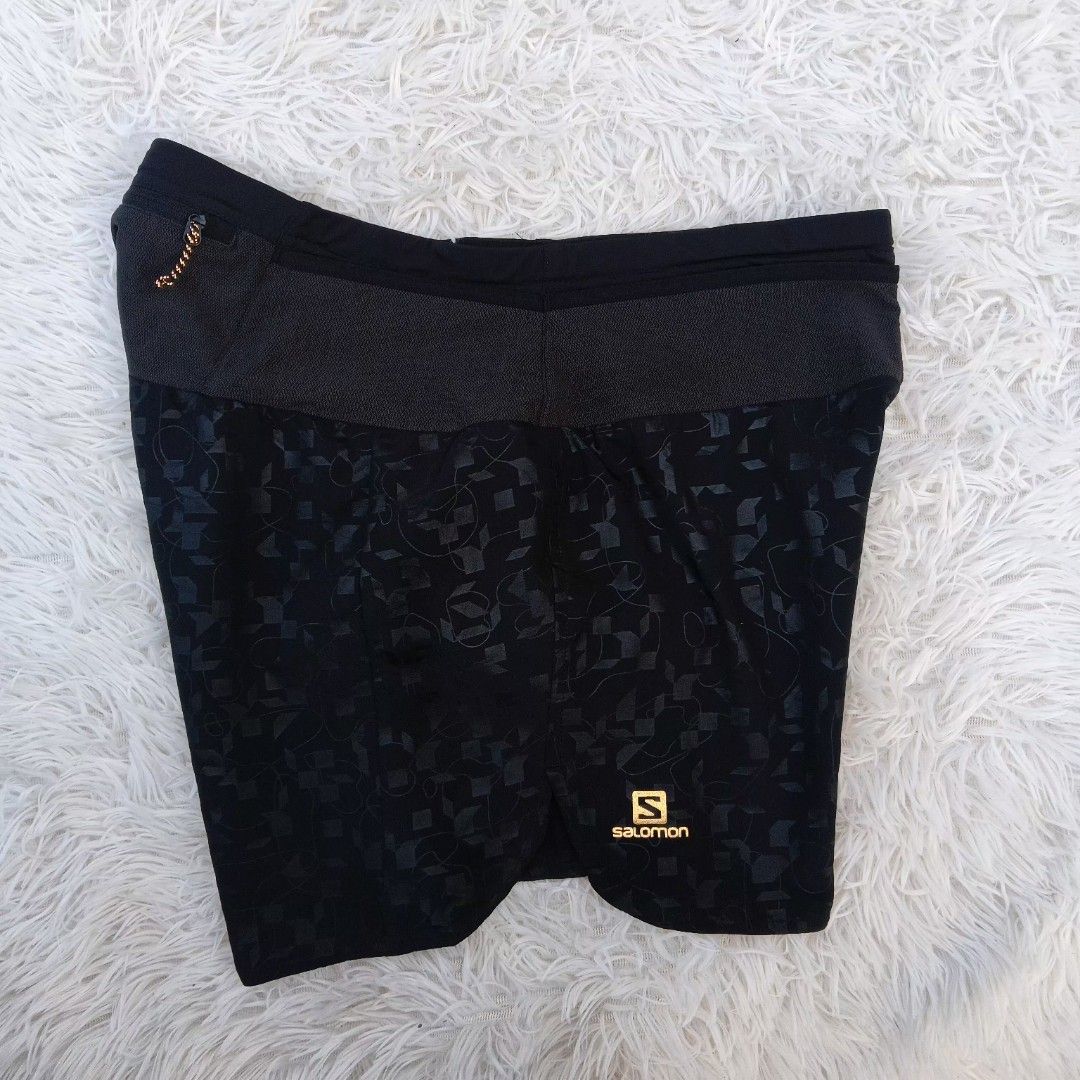 Salomon Black Running Shorts Size M (Category: Shorts) located in Gattaran. Submitted by thrift_wiseph (Listing ID 1468587170, Image 1). Description: - Brand: Salomon - Color: Black - Size: M (Made in Bangladesh) - Design: Patterned fabric with stylish gold Salomon branding and back stripe details - Storage: Built-in waistband pocket with secure zipper closure - Comfort: Breathable interior lining for maximum performance.
