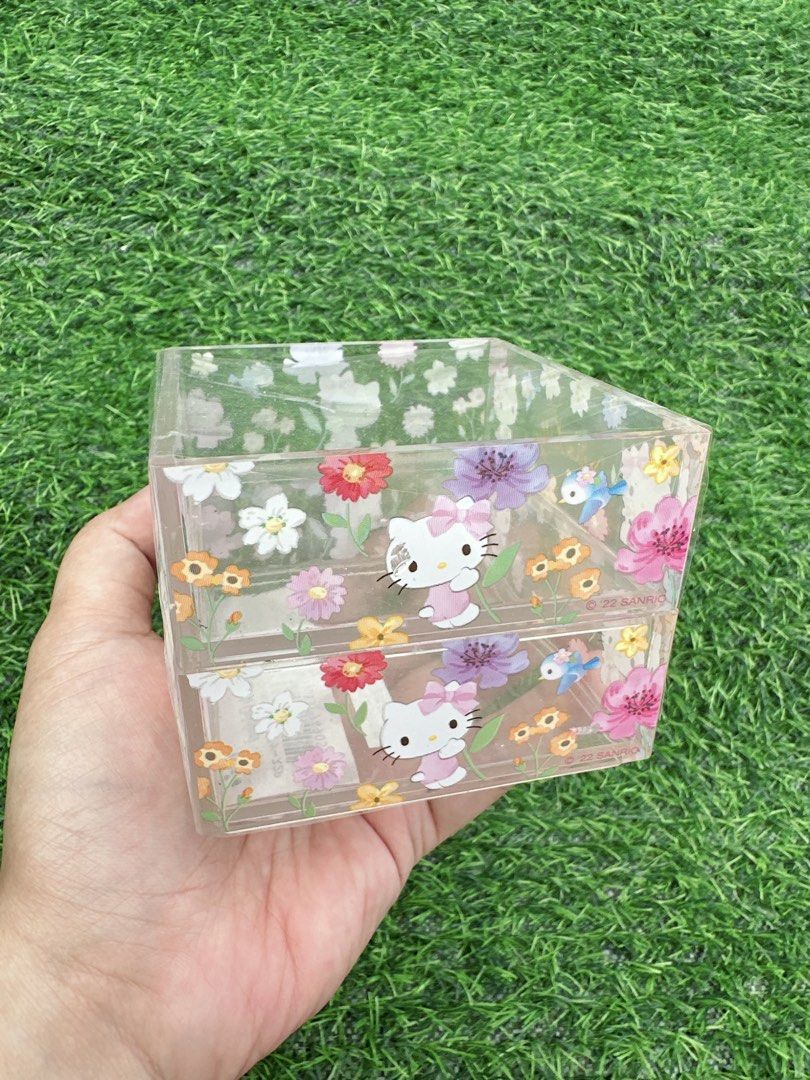 Sanrio Hello Kitty Floral Stacking Case Drawer Organizer (Category: Storage Boxes & Baskets) located in Manila. Submitted by ronoarabbit.ph (Listing ID 1468622128, Image 1). Description: ‼️old stock, from HT box, manage expectations‼️ - Official 2022 Sanrio merchandise featuring Kitty, flowers, and little blue birds - Two stackable drawers for organizing stationery, cosmetics, jewelry, or small desk items - Clear plastic design lets you easily se