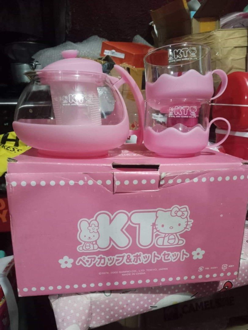 Sanrio Hello Kitty KT Pink Teapot and Cup Set (Category: Coffee & Tea Tableware) located in Manila. Submitted by janetecson05 (Listing ID 1468574496, Image 1). Description: - Official Sanrio 2002 vintage merchandise - Includes glass teapot with a removable infuser insert - Comes with 2 matching glass cups in cute pink silicone holders - Complete with the original pink polka dot presentation box - Perfect for Kitty collectors and tea lovers.