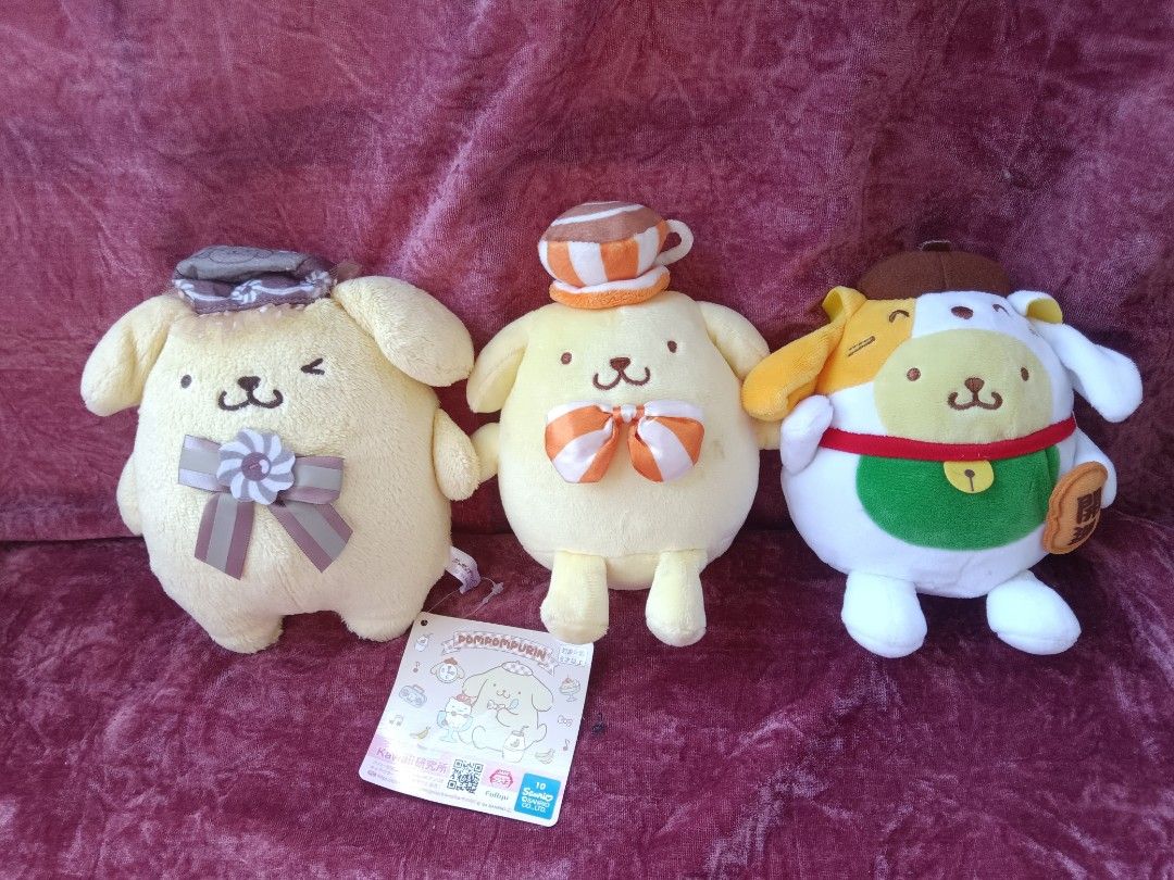Sanrio Pompompurin and McDonald's Plush Toy Bundle (Category: Plushies & Soft Toys) located in Cabuyao City. Submitted by jimcollections (Listing ID 1468685122, Image 1). Description: - Authentic Sanrio Pompompurin plush toy bundle (set of 3) - Plush 1: Features an orange and white ribbon with a cup hat and includes an official swing tag - Plush 2: Adorable winking expression wearing a purple bonnet and matching bow - Plush 3: Dressed in a green 