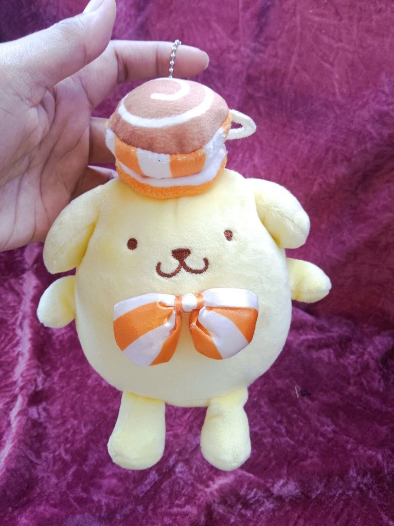 Sanrio Pompompurin and McDonald's Plush Toy Bundle (Category: Plushies & Soft Toys) located in Cabuyao City. Submitted by jimcollections (Listing ID 1468685122, Image 2). Description: - Authentic Sanrio Pompompurin plush toy bundle (set of 3) - Plush 1: Features an orange and white ribbon with a cup hat and includes an official swing tag - Plush 2: Adorable winking expression wearing a purple bonnet and matching bow - Plush 3: Dressed in a green 