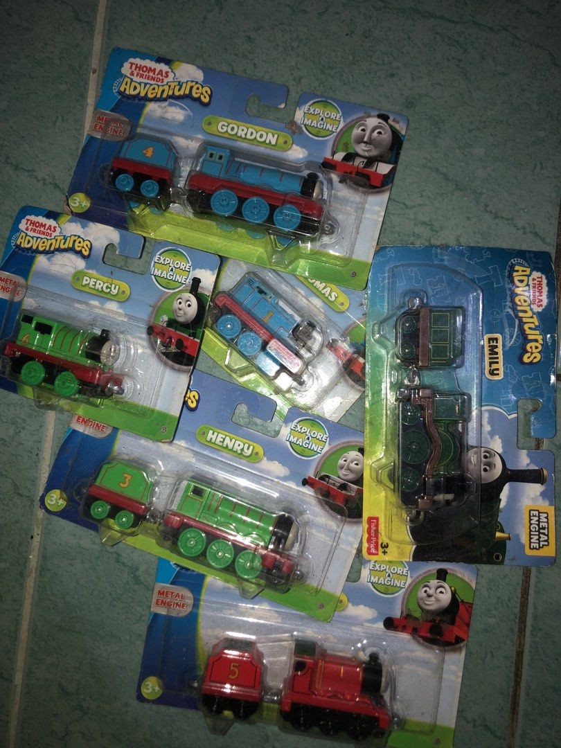 Sealed Thomas & Friends Adventures Metal Engine Toy Train Set (6 Pack) (Category: Vehicle & Diecast Models) located in Angeles City. Submitted by bratzdylan (Listing ID 1468647360, Image 1). Description: - Complete set of 6 Thomas & Friends Adventures metal engine toy trains - Includes fan-favorite characters: Gordon, Emily, Percy, Thomas, Henry, and James - 100% brand new in original, unopened blister pack packaging - Perfect gift for young chil