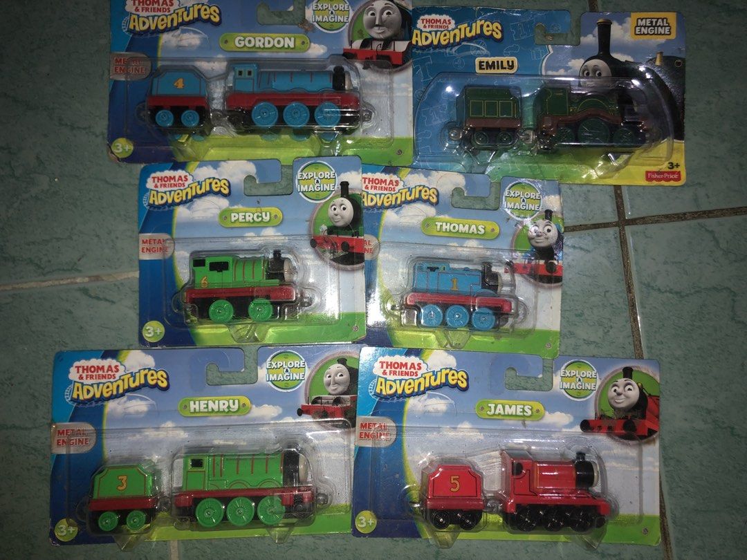 Sealed Thomas & Friends Adventures Metal Engine Toy Train Set (6 Pack) (Category: Vehicle & Diecast Models) located in Angeles City. Submitted by bratzdylan (Listing ID 1468647360, Image 2). Description: - Complete set of 6 Thomas & Friends Adventures metal engine toy trains - Includes fan-favorite characters: Gordon, Emily, Percy, Thomas, Henry, and James - 100% brand new in original, unopened blister pack packaging - Perfect gift for young chil