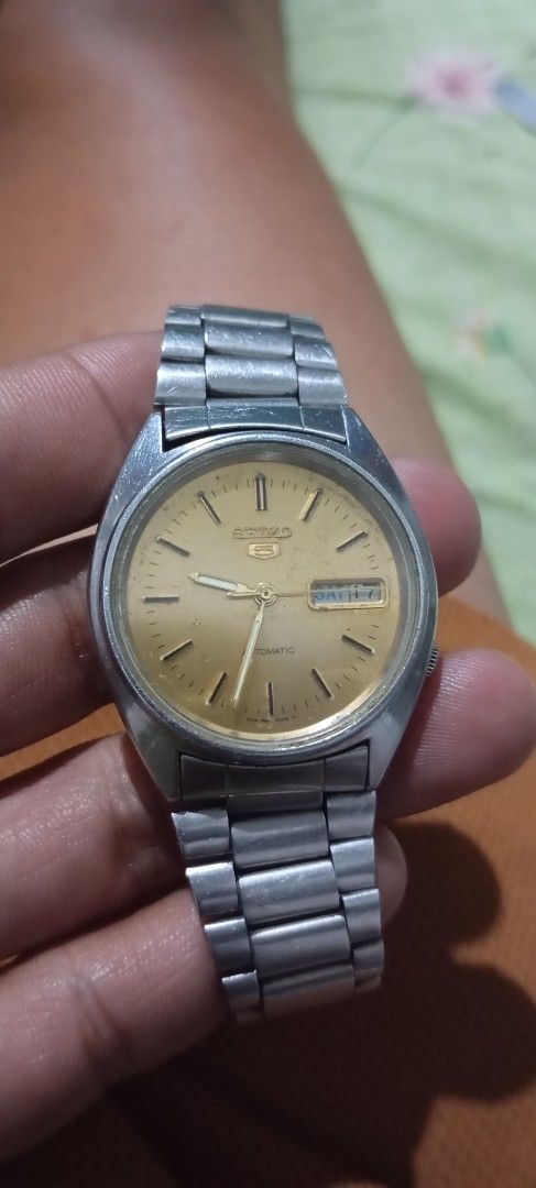 Seiko 5 Automatic Vintage Watch 7009-876A (Category: Men's Watches) located in Manila. Submitted by jhonevanma58082 (Listing ID 1468642545, Image 2). Description: - Brand: Seiko 5 Automatic - Dial: Champagne gold with day-date function at 3 o'clock - Case & Bracelet: Silver-tone metal with matching steel bracelet - Reference: Serial #474074, Movement Ref. 7009-876A - Condition: Noticeable wear on crystal, case, and bracelet from regular use - Fun