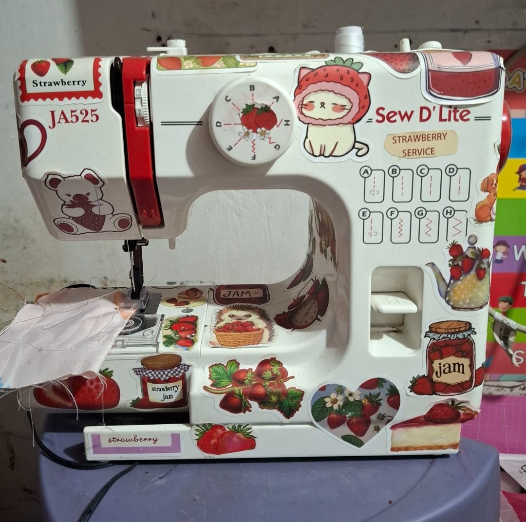 Sew D'Lite JA525 Strawberry Sewing Machine (Category: Craft Supplies & Tools) located in Paranaque City. Submitted by strawberryeng (Listing ID 1468578044, Image 2). Description: - Model: Sew D'Lite JA525 mini sewing machine - Custom design: Covered with adorable strawberry and dessert stickers - Condition: Tested and stitches properly on fabric scrap - Power: Works on DC6V 1200mA power - Inclusions: Matching foot pedal controller included - Idea