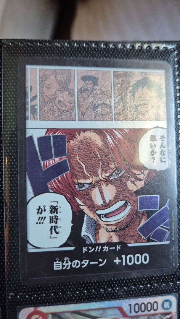 Shanks (Category: Raw Singles) located in Muntinlupa City. Submitted by lazoftoys (Listing ID 1468511251, Image 1). Description: - Item: One Piece Trading Card Game DON!! Card - Character/Design: Shanks with manga panel art - Language/Region: Japanese Version (Bandai) - Condition: Pack-fresh, pulled straight to binder sleeve (Clean surface, sharp corners) - Ideal for: Collectors and themed deck building.