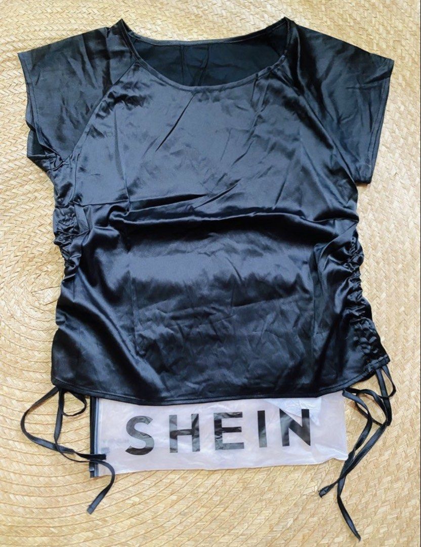 SHEIN Black Satin Drawstring Sides Top (Category: Blouses) located in Marikina City. Submitted by jessylady10 (Listing ID 1468633072, Image 1). Description: - Brand: SHEIN - Color: Black - Material: Smooth, shiny satin - Size: M (EU 38, US 6) - Condition: Brand new with tag, still in original plastic packaging - Features: Adjustable side drawstrings for a customized fit, round neckline, short sleeves Gcash payment and lalamove delivery or J&T shi