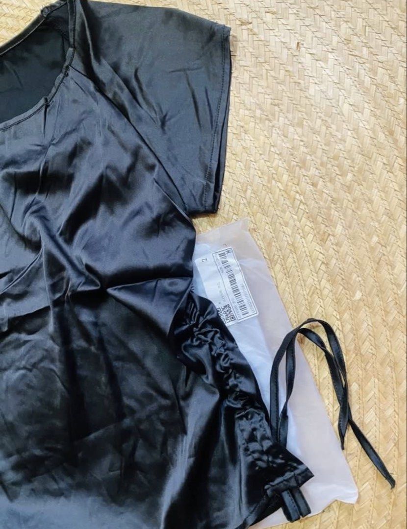 SHEIN Black Satin Drawstring Sides Top (Category: Blouses) located in Marikina City. Submitted by jessylady10 (Listing ID 1468633072, Image 2). Description: - Brand: SHEIN - Color: Black - Material: Smooth, shiny satin - Size: M (EU 38, US 6) - Condition: Brand new with tag, still in original plastic packaging - Features: Adjustable side drawstrings for a customized fit, round neckline, short sleeves Gcash payment and lalamove delivery or J&T shi