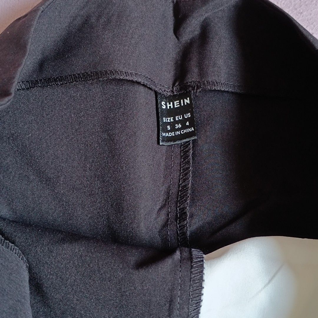 Shein Black Skirt Size S (Category: Skirts) located in Manila. Submitted by its.me.jo (Listing ID 1468550124, Image 2). Description: - Brand: Shein - Style: Black mini skirt with asymmetric wrap detail (light mint/white underneath) - Size: S / EU 36 / US 4 - Closure: Side zipper - Condition: Clean fabric - Perfect for styling with basic tees and blouses.