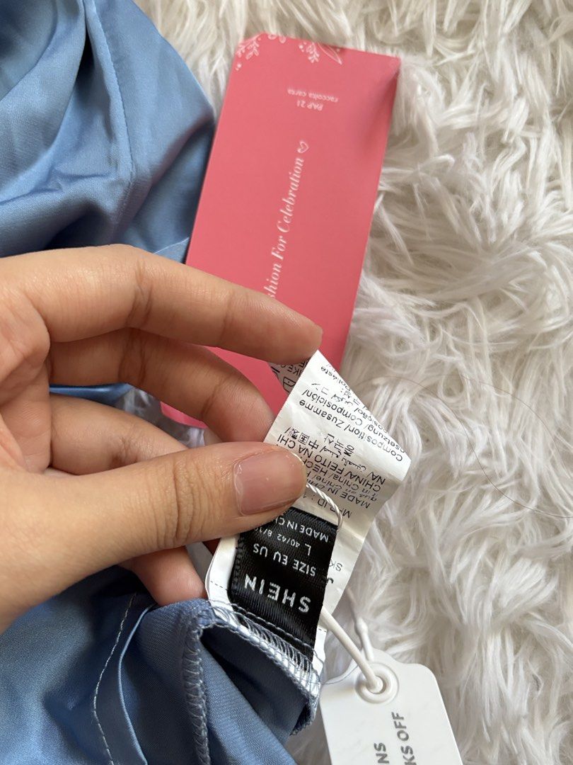 SHEIN Blue Satin Ruched Midi Dress (Category: Dresses) located in Quezon City. Submitted by lovedbysloane (Listing ID 1468596294, Image 2). Description: - Can fit M-L - Brand new with tags (BNWT), never worn - Size: L (true to size) - Color: Dusty blue - Material: Silky satin finish - Design: Spaghetti straps, elegant cowl neckline, and flattering side ruching - Occasion: Ideal for weddings, parties, and formal events.