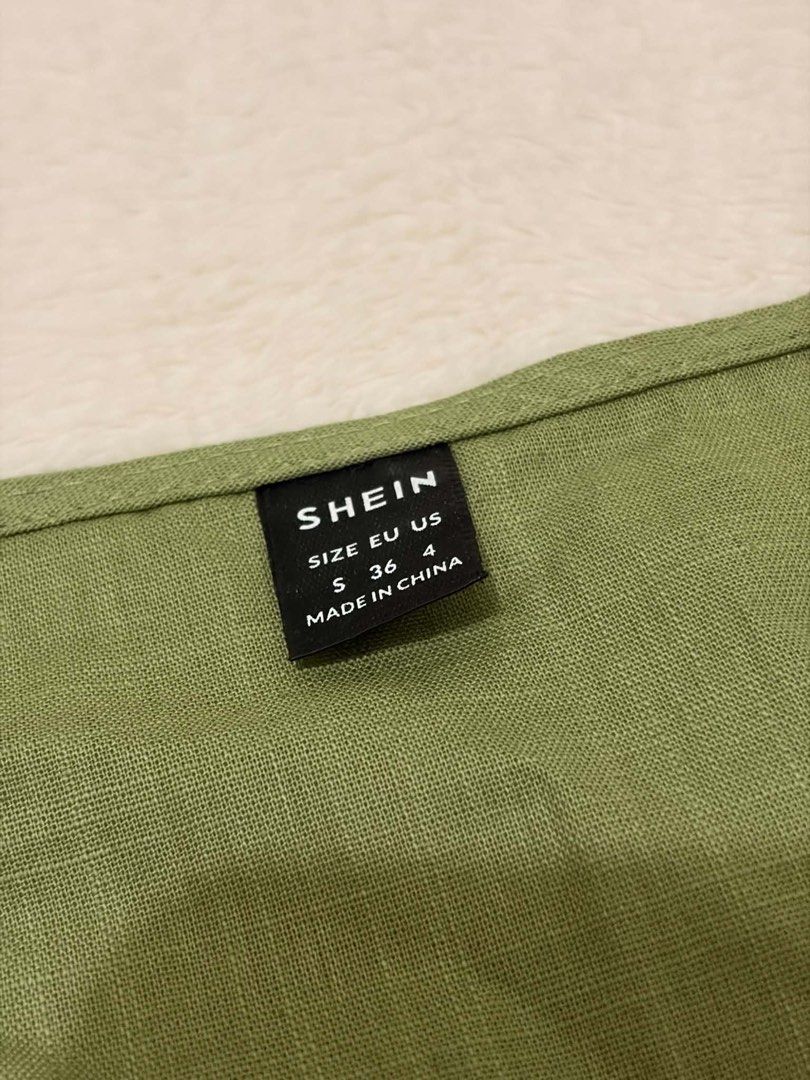 SHEIN Green Tie Front Scallop Hem Blouse (Category: Blouses) located in Manila. Submitted by janellecas75114 (Listing ID 1468644784, Image 3). Description: - Brand: SHEIN - Color: Green - Size: S (Fits EU 36 / US 4) - Style: V-neck with 3 front tie closures, puff sleeves with elastic cuffs, and scalloped hem - Fabric: Lightweight textured material with a subtle grid pattern - Condition: Great, clean, and ready to wear.
