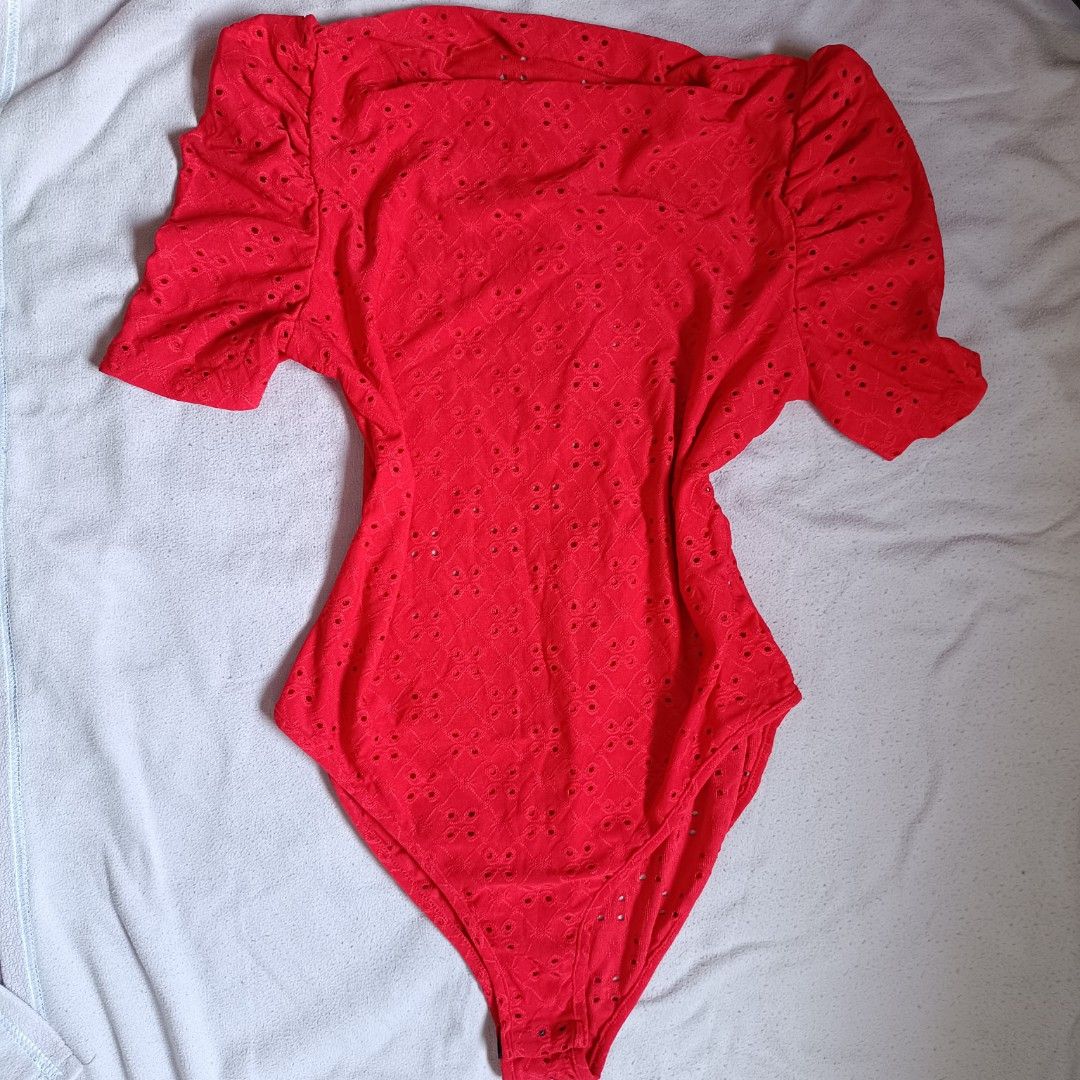 Shein Red Eyelet Bodysuit Size L (Category: Blouses) located in Manila. Submitted by its.me.jo (Listing ID 1468550787, Image 1). Description: - Color: Bright red - Brand: Shein - Size: L (Fits US 8/10 or EU 40/42) - Design: Eyelet cutout pattern, square neckline, and trendy puff short sleeves - Closure: Convenient bottom snap buttons - Material: 95% polyester, 5% elastane (stretchy and comfortable) - Care: Machine washable.