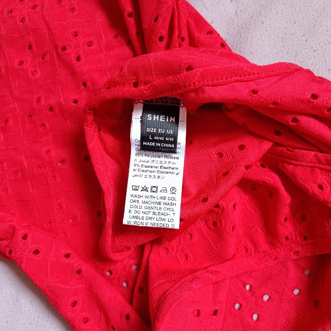 Shein Red Eyelet Bodysuit Size L (Category: Blouses) located in Manila. Submitted by its.me.jo (Listing ID 1468550787, Image 3). Description: - Color: Bright red - Brand: Shein - Size: L (Fits US 8/10 or EU 40/42) - Design: Eyelet cutout pattern, square neckline, and trendy puff short sleeves - Closure: Convenient bottom snap buttons - Material: 95% polyester, 5% elastane (stretchy and comfortable) - Care: Machine washable.