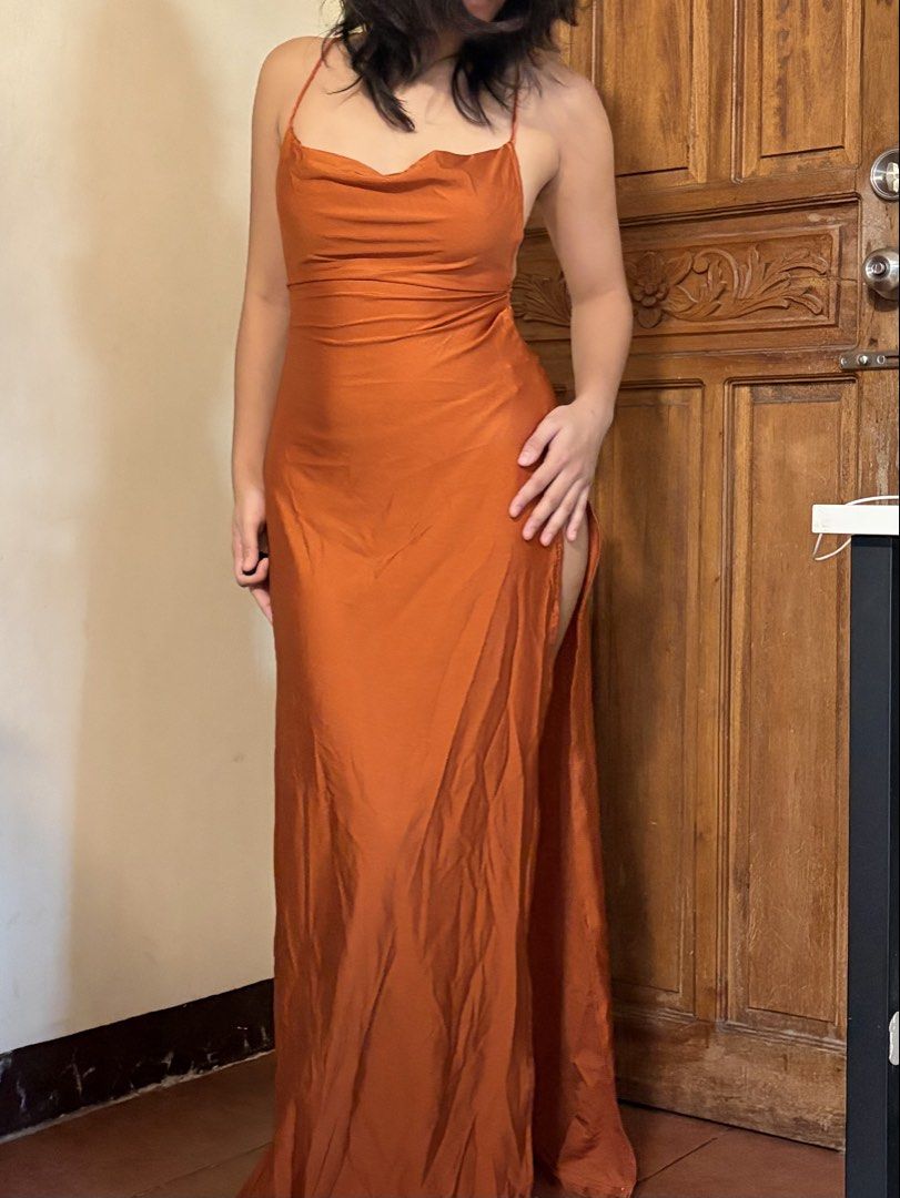 SHEIN Rust Orange Satin Double High Slit Open Back Dress (Category: Dresses) located in Pasig City. Submitted by catherinea38704 (Listing ID 1468605706, Image 2). Description: - Color: Rust Orange - Material: satin - Design: Cowl neckline with sleeveless thin straps - Back Detail: Adjustable criss-cross tie back - Fit & Cut: Full length, flowy fit with a high left-leg side slit - Condition: Brand new / Excellent (ready to wear) never used Perfect