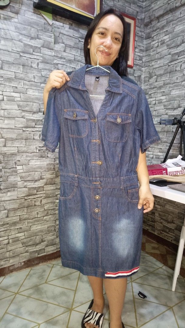 Short sleeve denim dress with front button closure (Category: Dresses) located in Antipolo. Submitted by reahespiritu (Listing ID 1468661805, Image 1). Description: - Style: Casual blue denim shirt dress - Features: Short sleeves, pointed collar, and front button-down closure - Pockets: Two chest pockets and two lower pockets - Details: Trendy washed faded effect on the skirt - Accent: Stylish red and white stripe on the bottom hem - Condition: G