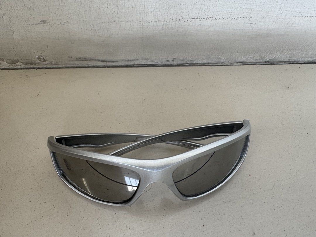 Silver Y2K Futuristic Wrap Around Sunglasses (Category: Sunglasses & Eyewear) located in Manila. Submitted by decluterthings888 (Listing ID 1468579558, Image 2). Description: - Style: Futuristic wrap-around design with a sleek silver frame - Lenses: Dark tinted for ultimate sun protection - Versatility: Perfect for casual streetwear, outdoor sports, and techwear aesthetics - Condition: Solid build quality with minimal signs of wear, ready for dai