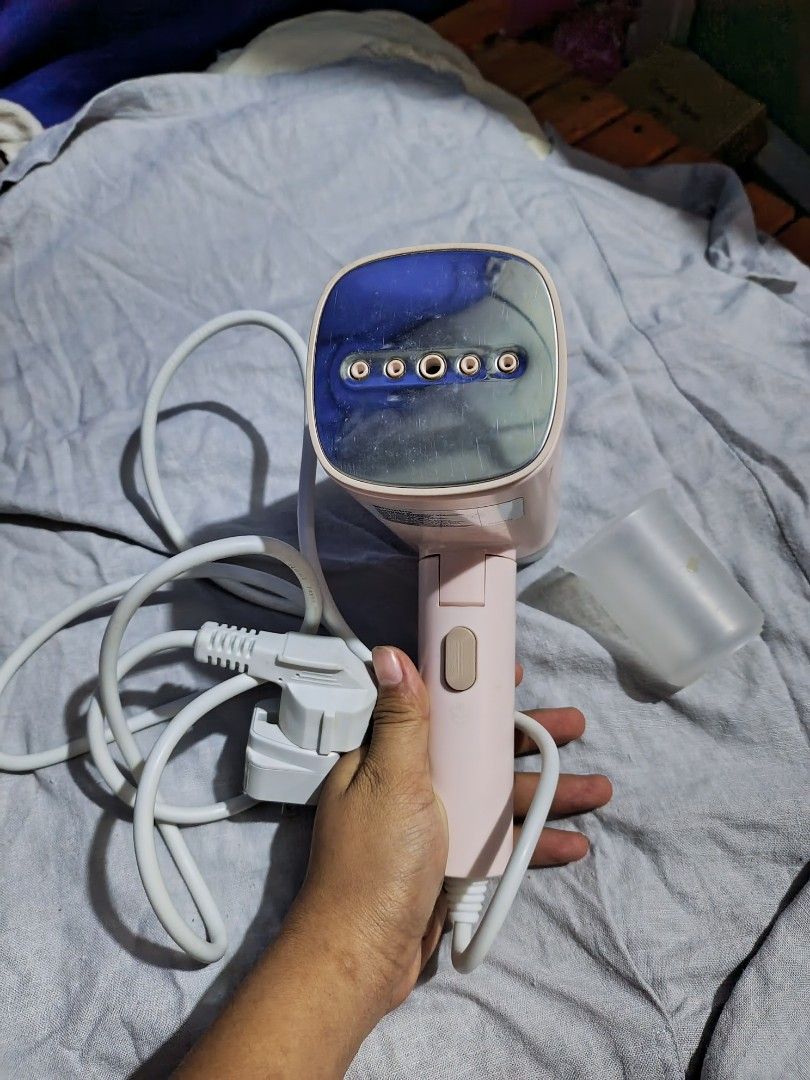 Simplus Handheld Garment Steamer with Measuring Cup (Category: Irons & Steamers) located in Manila. Submitted by shainamae09 (Listing ID 1468679422, Image 2). Description: ‼️RUSH SALE 700 - Brand: Simplus - Color: Cute pink design - Type: Portable handheld garment steamer - Inclusions: Water tank, measuring cup, and power cord with plug - Performance: Steam panel with multiple outlets for efficient steaming - Best for: Quick and convenient clothe