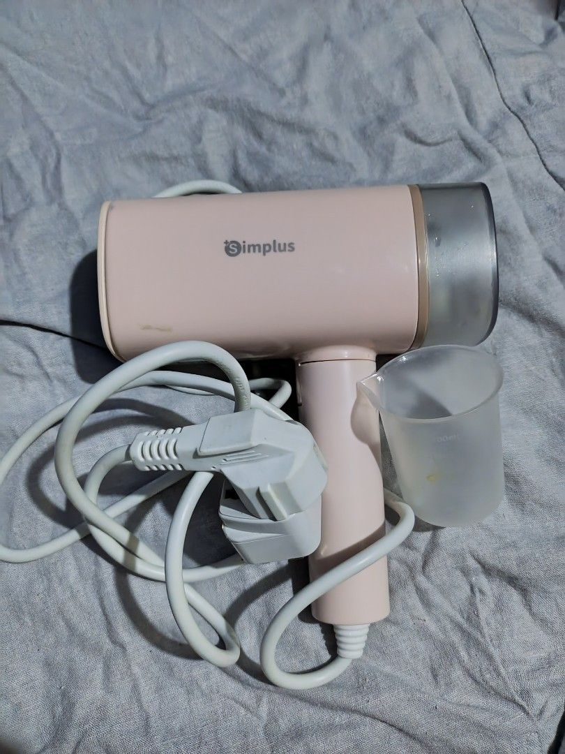 Simplus Handheld Garment Steamer with Measuring Cup (Category: Irons & Steamers) located in Manila. Submitted by shainamae09 (Listing ID 1468679422, Image 1). Description: ‼️RUSH SALE 700 - Brand: Simplus - Color: Cute pink design - Type: Portable handheld garment steamer - Inclusions: Water tank, measuring cup, and power cord with plug - Performance: Steam panel with multiple outlets for efficient steaming - Best for: Quick and convenient clothe