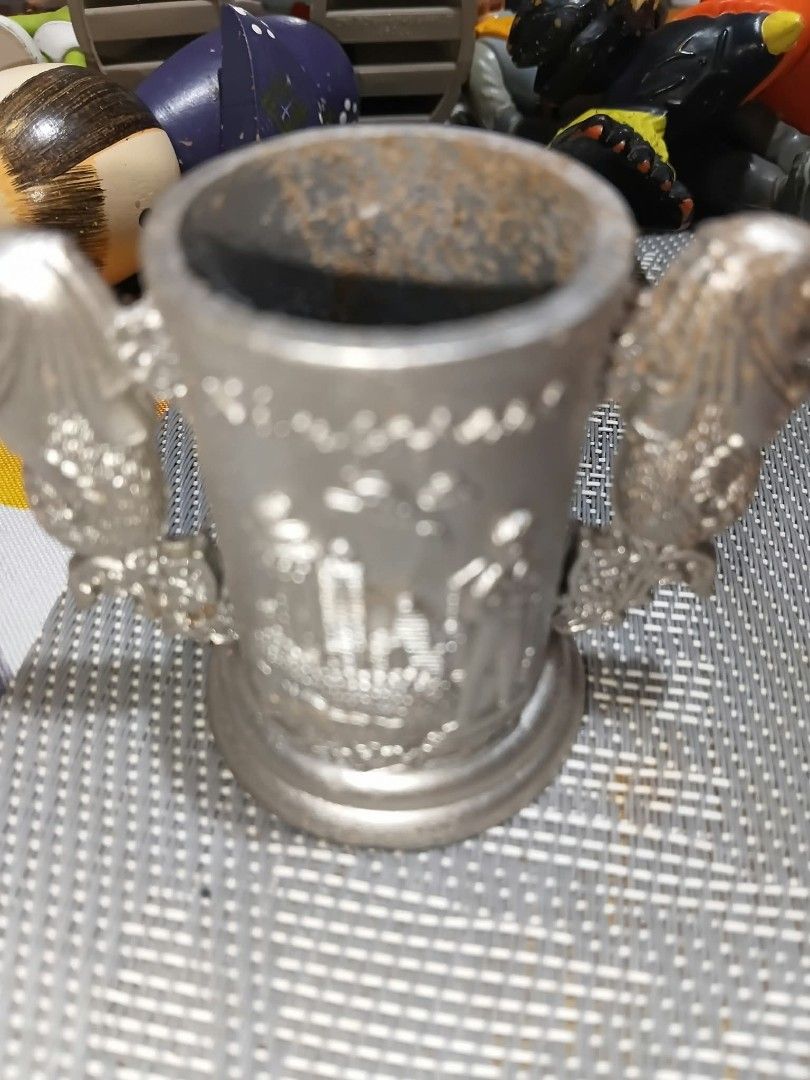 Singapore Merlion toothpick holder and mini fork set (Category: Vintage Collectibles) located in Manila. Submitted by briansun18 (Listing ID 1468529757, Image 1). Description: - Authentic metal souvenir set from Singapore - Includes a small trophy-shaped holder with iconic Merlion handles and skyline engraving - Comes with a matching set of small two-pronged fruit forks with detailed Merlion handles - Forks are still sealed in their original plas