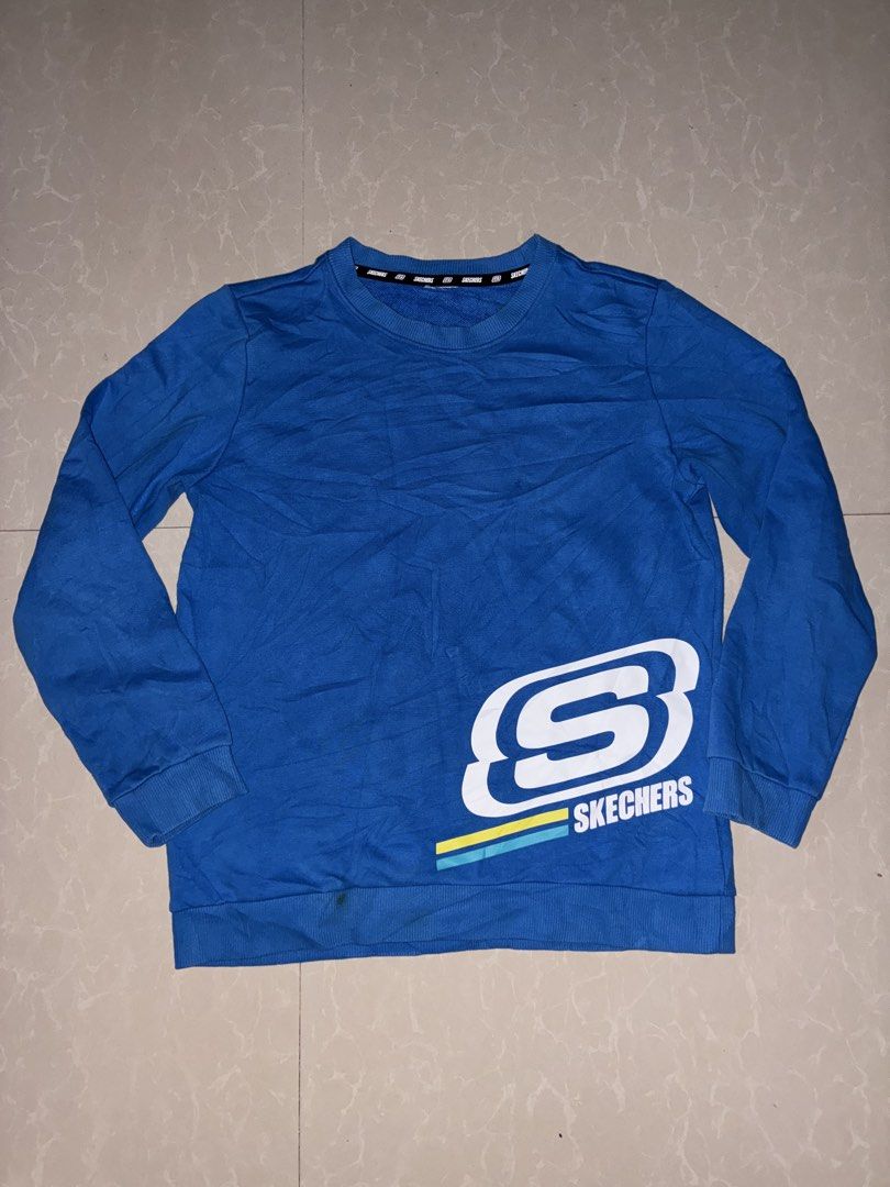 Skechers Blue Sweatshirt with Logo (Category: Coats, Jackets and Outerwear) located in Placer. Submitted by talaalond61563 (Listing ID 1468710204, Image 1). Description: - Brand: Skechers - Color: Bright blue with white, yellow, and teal accents - Style: Casual long-sleeve pullover crewneck sweatshirt - Details: Large 'S' logo graphic with accent stripes on front, matching branding near back neckline, and branded inside collar taping - Fit: Ribbe