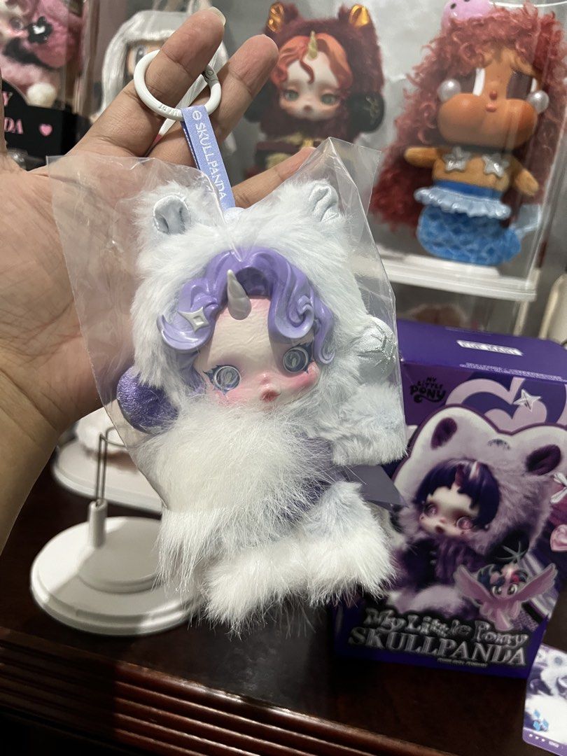 SKULLPANDA X MLP - Rarity (Category: Plushies & Soft Toys) located in Valenzuela. Submitted by greyzeep (Listing ID 1468550469, Image 3). Description: Rarity - Skullpanda X My Little Pony ₱1,000 only from PopNow 💜💜💜 Doll displayed on sealed acrylic case ONLY Complete inclusions (box, hair net, pouch and card) ❗️Please see minimal factory issue on photos posted (pink dot on hair, not noticeable) RFS: Downsizing collection 📝Pay as you order Mod