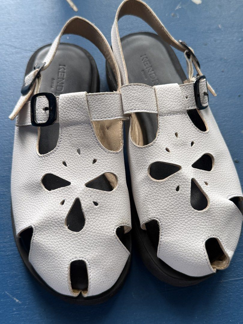 Slip On Sandals White Size 6 (Category: Flats & Sandals) located in Iloilo. Submitted by qwertrisha (Listing ID 1468510919, Image 2). Description: - Brand/Model: Kendra Manila Astra Slip-on Sandals - Color: White - Size: 6 - Material: Textured faux leather with laser-cut floral details USED ONLY ONCE. VERY COMFORTABLE TO USE AND VERY LIGHT WEIGHT.