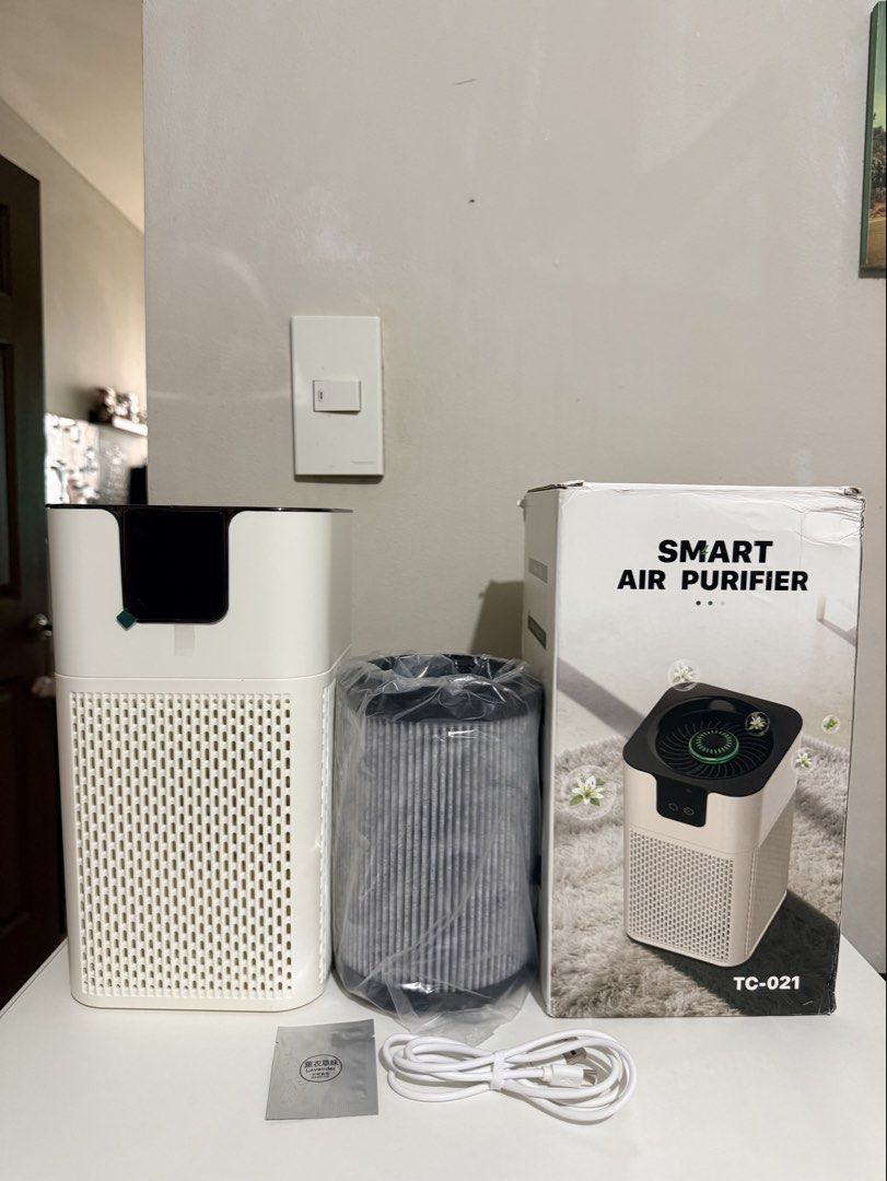 Smart Air Purifier TC-021 with Filter and Cable (Category: Air Purifiers & Dehumidifiers) located in Pasig City. Submitted by thetravellingguyinstyle (Listing ID 1468690479, Image 1). Description: - Model: TC-021 Smart Air Purifier (White) - Brand new: Complete with box - Inclusions: Main unit, brand new unused replacement filter in plastic, USB power cable, and lavender fragrance sachet - Perfect for improving air quality in any room.