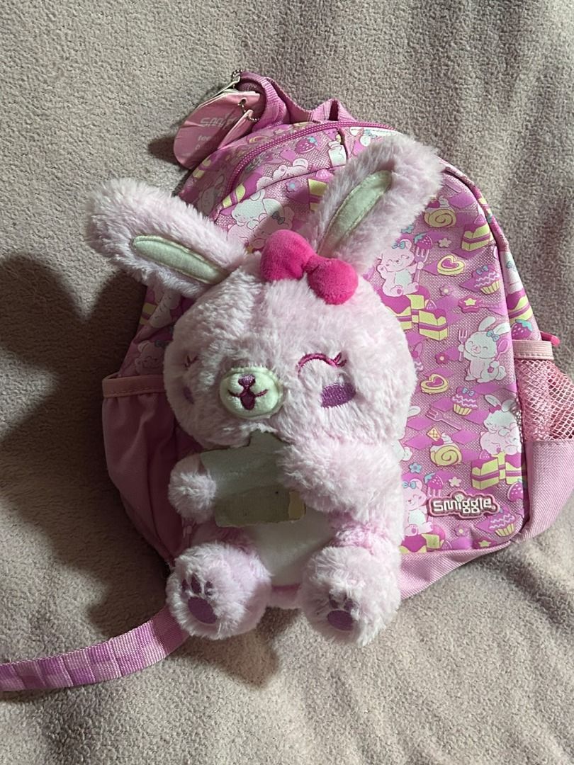 Smiggle Backpack with Removable Plush Toy Pink (Category: Backpacks) located in Las Pinas. Submitted by whatzupriley (Listing ID 1468549755, Image 3). Description: - Brand: Smiggle Teeny Tiny - Design: Bright pink with all-over dessert and bunny pattern - Bonus: Includes a detachable fluffy pink bunny plush toy - Features: Pink mesh side pockets and adjustable straps - see photos for details - Ideal for: Kids.