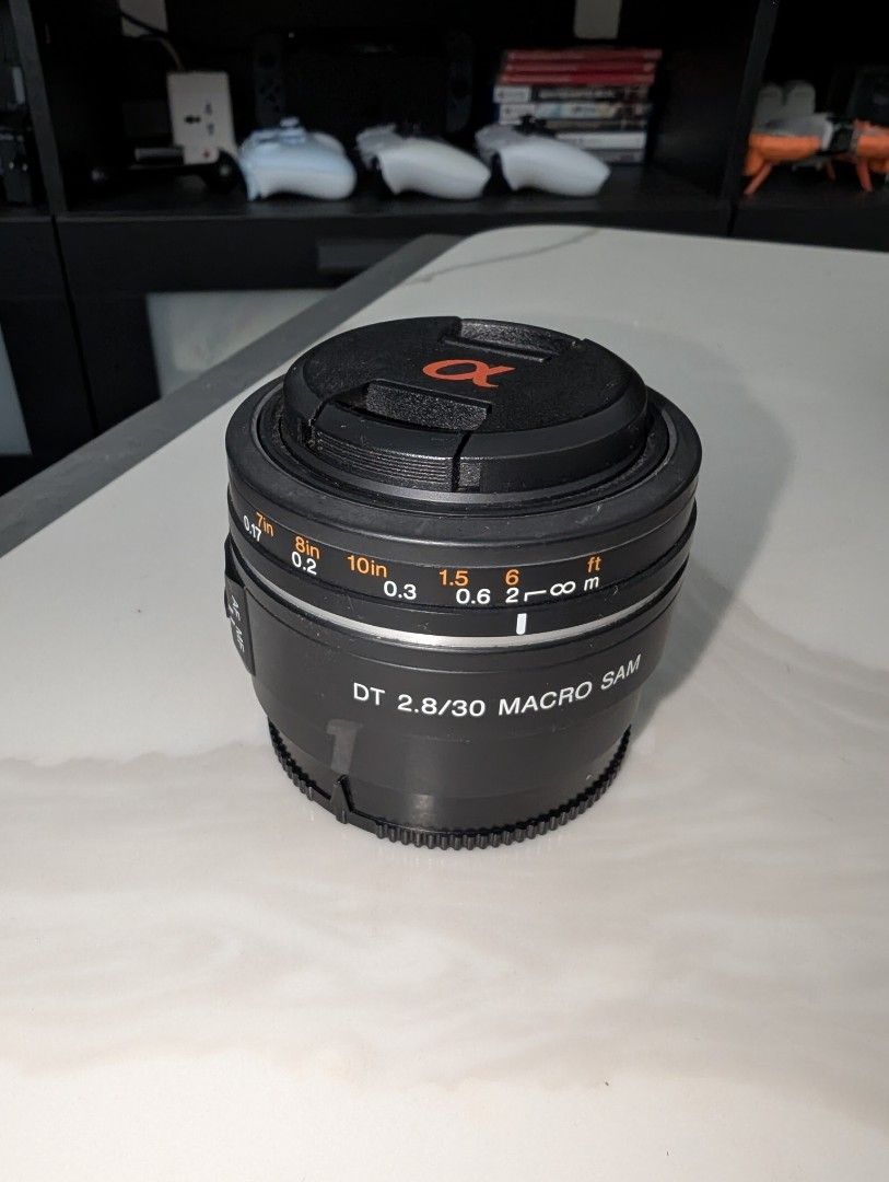 Sony DT 2.8/30 Macro SAM Lens (Category: Lens & Kits) located in Santa Rosa. Submitted by vansting (Listing ID 1468505211, Image 1). Description: - Model: Sony DT 2.8/30 Macro SAM lens - Mount: Sony Alpha mount - Type: Compact prime lens ideal for macro and close-up photography - Features: Focus distance scale in feet and meters, standard AF/MF switch - Condition: Clean glass elements inside - Inclusion: Front lens cap with iconic orange Alpha lo