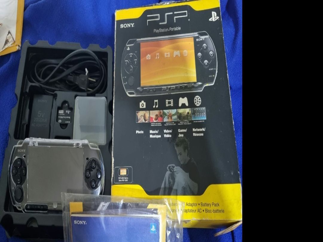 Sony PSP-2000 PlayStation Portable Console Boxed (Category: PlayStation) located in Angeles City. Submitted by roshangaming (Listing ID 1468568797, Image 2). Description: - Sony PSP-2000 handheld console in original box - Includes power adapter and spare battery pack - 8GB memory stick included for storage - Comes with original manuals and clear protective hard case - Stored neatly in original packaging inserts - Perfect all-in-one retro gaming b