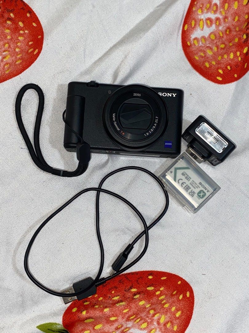 Sony ZV-1 Vlogging Camera with Battery and Cable (Category: Cameras) located in Manila. Submitted by rubyannlucy (Listing ID 1468568768, Image 2). Description: - Model: Sony ZV-1 Compact Camera - Lens: High-quality Zeiss Vario-Sonnar T* - Screen: Flips out LCD, perfect for vlogging and selfies - Condition: Powers on and shoots normally, fully functional - Included: NP-BX1 rechargeable battery, external flash attachment, wrist strap, and USB charg