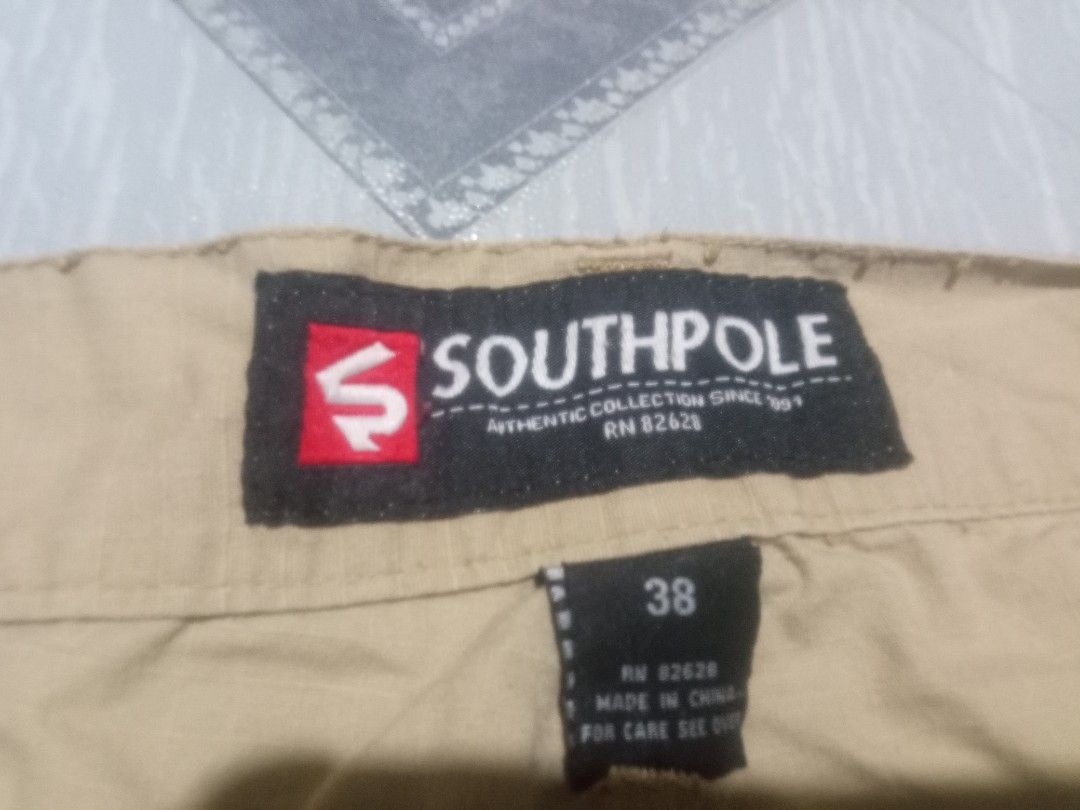 Southpole Cargo Shorts Khaki Size 38 (Category: Shorts) located in Manila. Submitted by boot_tdm (Listing ID 1468707116, Image 1). Description: - Brand: Southpole - Size: 38 - Color: Khaki - Material/Origin: Made in China (RN 82628) - Pockets: Multiple utility pockets on sides and back with button closures - Features: Adjustable drawstrings at the waist and leg openings - Style: Solid everyday casual wear.