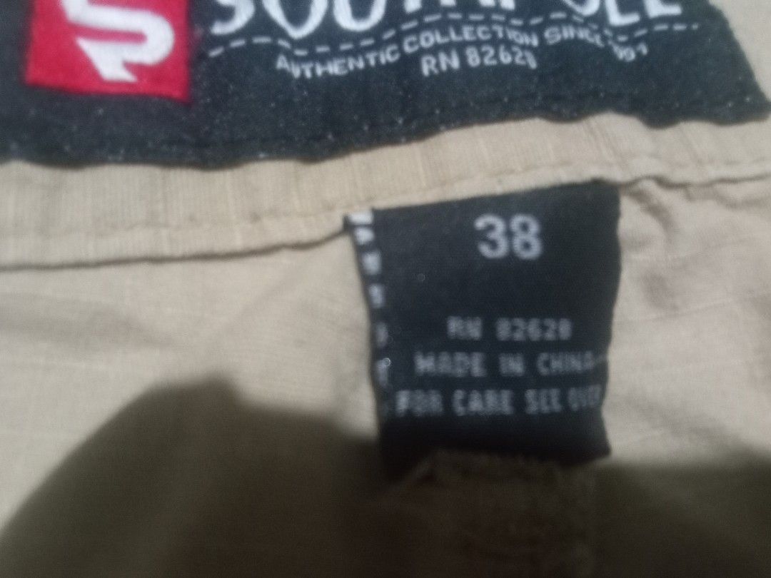 Southpole Cargo Shorts Khaki Size 38 (Category: Shorts) located in Manila. Submitted by xthirft_finderx (Listing ID 1468707183, Image 2). Description: - Brand: Southpole - Size: 38 - Color: Khaki - Material/Origin: Made in China (RN 82628) - Pockets: Multiple utility pockets on sides and back with button closures - Features: Adjustable drawstrings at the waist and leg openings - Style: Solid everyday casual wear.