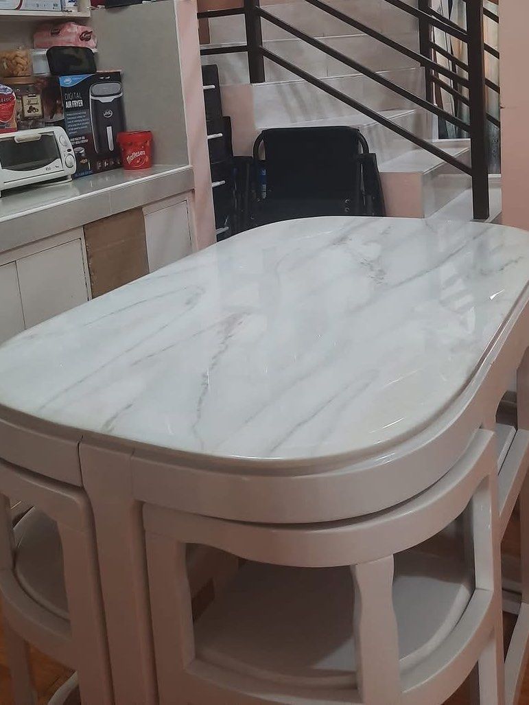 Space-Saving White Dining Table with 4 Stools (Category: Tables & Sets) located in Pasay City. Submitted by daisuki.x0x0 (Listing ID 1468504155, Image 1). Description: - Space-saving dining set ideal for small apartments and kitchens - Smooth white marble-pattern tabletop with a sturdy base - Includes 4 matching stools that tuck neatly underneath - Neutral cream-white finish blends with any interior - Easy to clean and maintain.