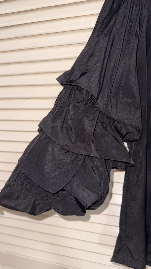 Black Off-Shoulder Blouse with Tiered Ruffle Sleeves (Category: Blouses) located in Manila. Submitted by oliviablanche (Listing ID 1468607185, Image 2). Description: - Bought in Spain - Color: Black - Style: Off-shoulder top with tiered ruffle sleeves - Fit: Stretchy elastic neckline, lightweight material - Versatility: Easy to pair with jeans or a skirt for a night out - Condition: Worn only once, clean and like new - Mode of Payment: GCash, BDO