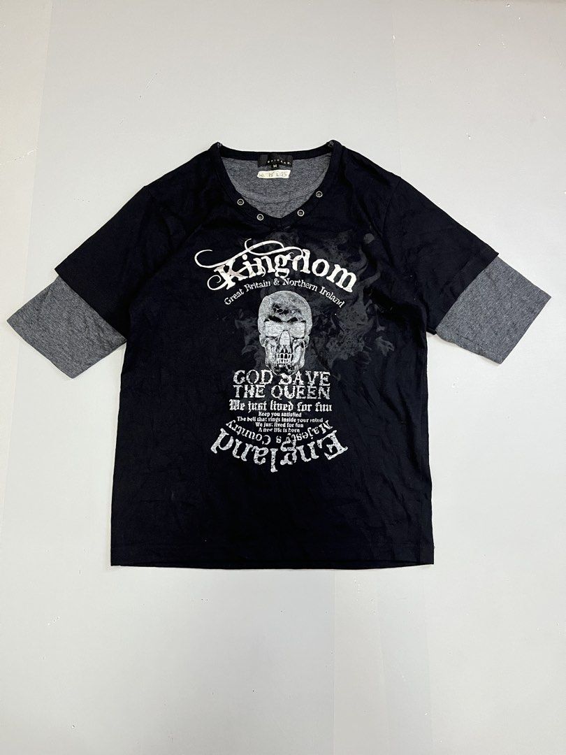 Spinash Skull Graphic T-shirt Size M (Category: Tshirts & Polo Shirts ) located in Mabalacat. Submitted by aas_thriftfings (Listing ID 1468572571, Image 1). Description: - Brand: Spinash - Size: Medium - Color/Style: Black and grey with layered sleeves - Design: Skull graphic print with typography on the front - Details: V-neck collar featuring metal eyelets - Material: Polyester and cotton blend - Condition: Clean and well-maintained.