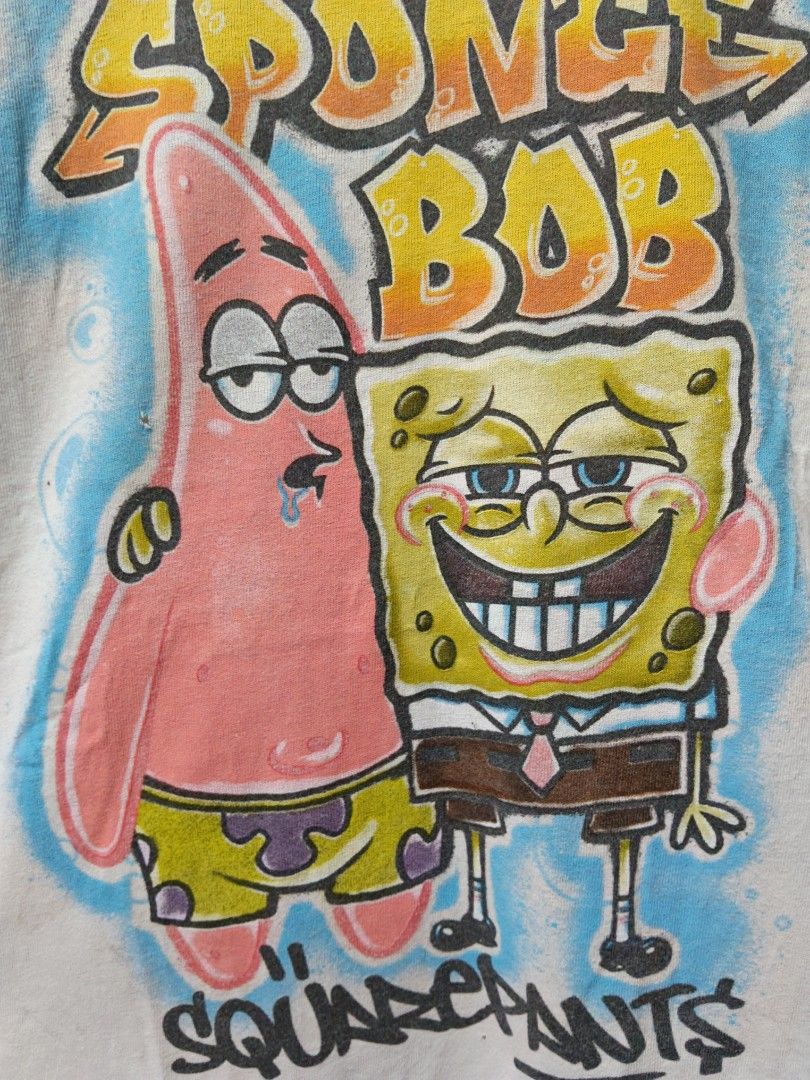 SpongeBob and Patrick Spray Graphics (Category: Tshirts & Polo Shirts ) located in Taguig. Submitted by thriftedminds (Listing ID 1468659235, Image 2). Description: Item: SpongeBob and Patrick🔥 ‎Size: Large (Nickelodeon) ‎Width: 21 ‎Length: 29.5 ‎Condition: Good ‎Issue: Pinhole, Deo stain DM to purchase 📩.