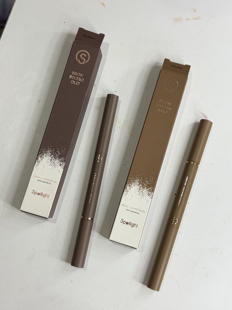 Spotlight Brow Studio Duo Pencil + Laminating Gel (Category: Makeup) located in Abucay. Submitted by declutterwyana (Listing ID 1468707151, Image 1). Description: - Brand new, unopened Spotlight Brow Studio Duo pens - Includes 2 shades: Burnt and Taupe - Dual-ended design featuring a brow pencil and laminating gel - Formula infused with castor oil for brow care - Ideal for everyday grooming and styling - Selling both shades together.