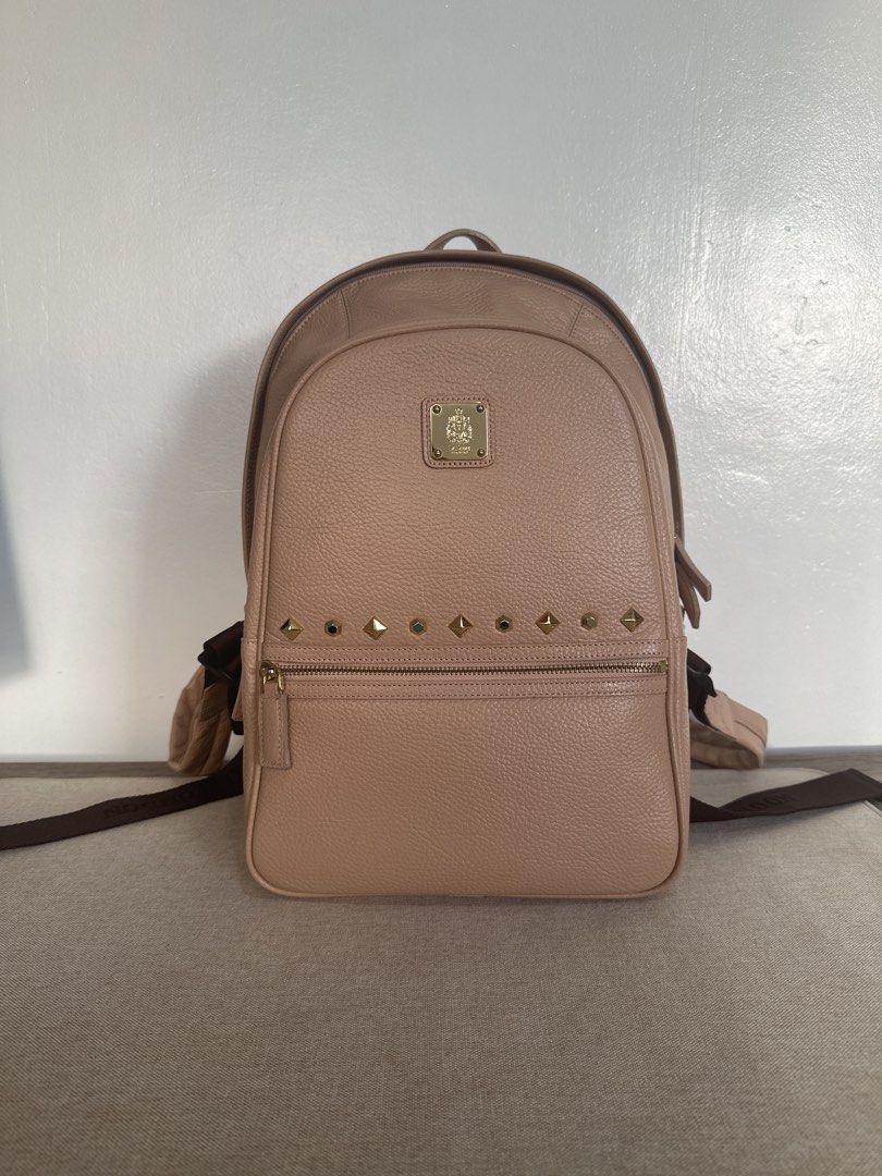 St. Scott London Leather Backpack in Cream (Category: Backpacks) located in Cainta. Submitted by xyzasisa (Listing ID 1468585154, Image 1). Description: - Brand: St. Scott London - Size: height-14.5 in, width-9.5 in, base-4.5in - Material: Premium beige pebbled leather with gold hardware - Exterior: Front zipper pocket with stylish stud details and a trendy quilted zigzag back panel - Interior: Clean burgundy lining featuring all-over printed bra