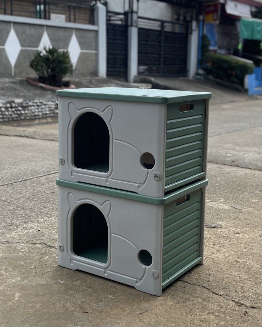 Stackable plastic cat house pet shelter grey green (Category: Storage Boxes & Baskets) located in Manila. Submitted by wassaup (Listing ID 1468517894, Image 2). Description: - Set of 2 stackable pet houses (Grey and Green) - Cute cat-ear shaped front entrance and fun side peek-a-hole - Modular design saves floor space with vertical stacking - Slatted side panels with integrated handles for easy carrying - Suitable for cats and small dogs - Clean 