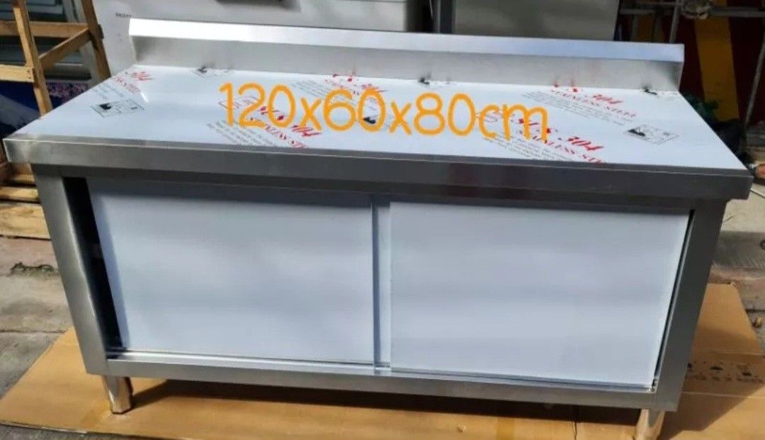 Stainless Steel Kitchen Work Table with Sliding Doors (Category: Tables & Sets) located in Manila. Submitted by oddcrystal_66a000 (Listing ID 1468543398, Image 1). Description: - Heavy-duty stainless steel work bench, size: 120x60x80cm - Built-in sliding doors underneath for organized storage - Solid, durable build ideal for restaurant kitchens, food prep, or garage workshops - Easy to wipe clean and maintain - Space-saving design.