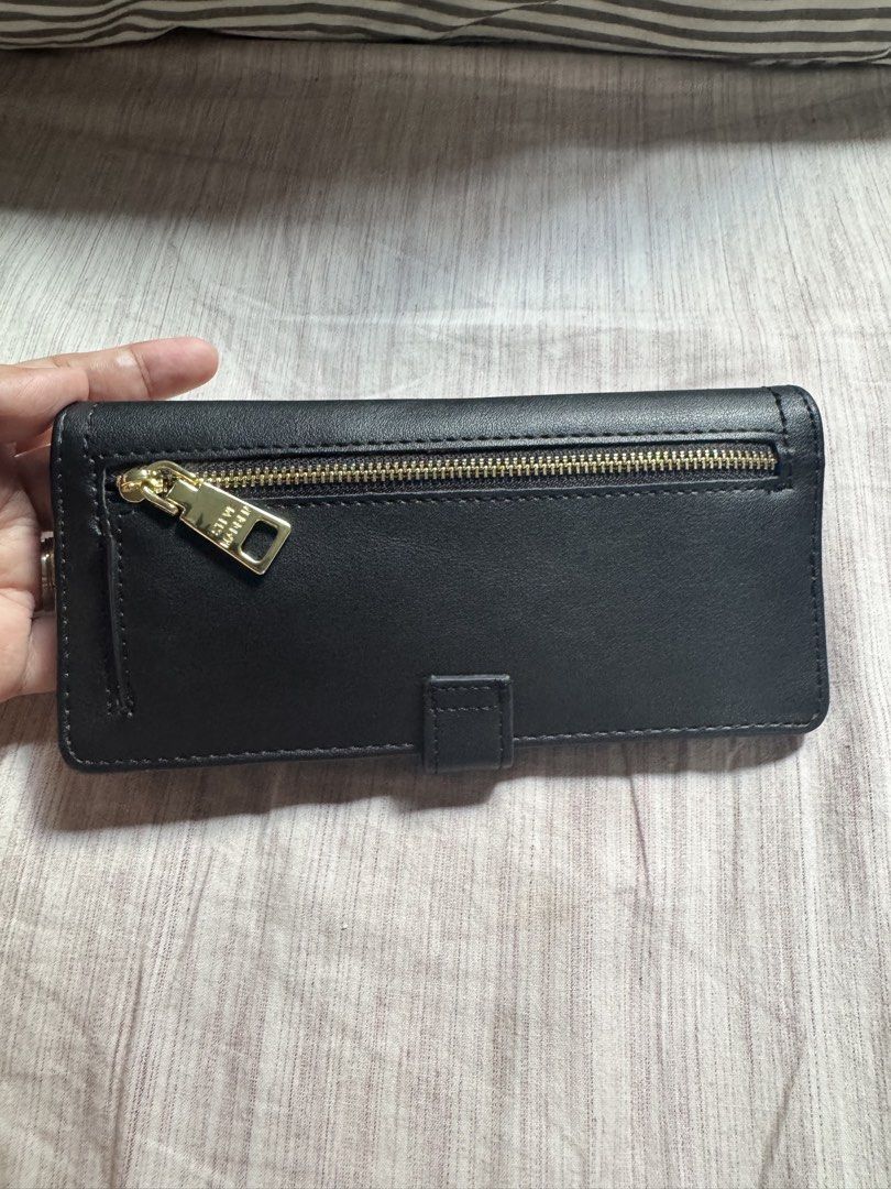 Steve Madden Black Long Wallet (Category: Wallets & Card holders) located in Las Pinas. Submitted by nautikath18 (Listing ID 1468552180, Image 2). Description: - Brand: Steve Madden - Color: Classic black with elegant gold-tone hardware - Closure: Secure front flap with snap button - Exterior: Convenient back zipper pocket - Interior: Multiple card slots and a clear ID window - Condition: Clean interior, very well-maintained, ideal for everyday u